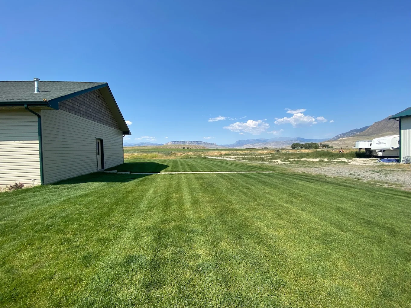 Wide green lawn with mountain view